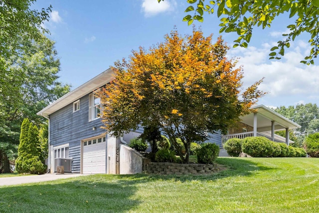 21 Vicki St, Nancy, KY 42544 - view of property exterior featuring an attached garage, a yard, driveway, and cooling unit