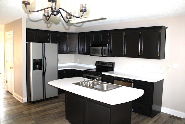178 Ridgewater Dr, Somerset, KY 42503 - kitchen featuring appliances with stainless steel finishes, dark cabinetry, a chandelier, and dark wood-style floors