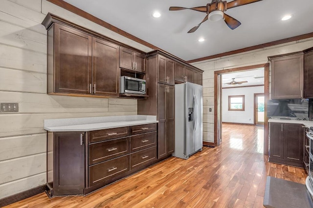 372 Sussex Ln, Nicholasville, KY 40356 - kitchen with appliances with stainless steel finishes, ceiling fan, light countertops, dark brown cabinets, and light wood-type flooring
