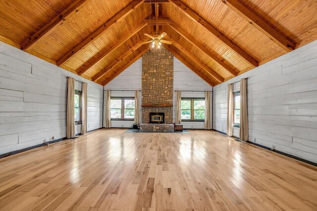 372 Sussex Ln, Nicholasville, KY 40356 - unfurnished living room with wood finished floors, ceiling fan, wood walls, wooden ceiling with exposed beams, and a stone fireplace