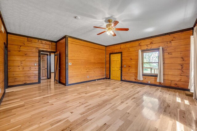 372 Sussex Ln, Nicholasville, KY 40356 - empty room featuring ceiling fan, wooden walls, and light wood finished floors