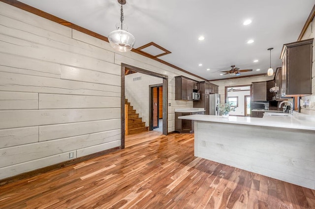372 Sussex Ln, Nicholasville, KY 40356 - kitchen featuring appliances with stainless steel finishes, dark brown cabinets, light countertops, a peninsula, and a sink