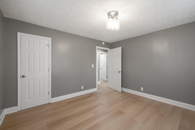 710 E Main St, Danville, KY 40422 - unfurnished room featuring a textured ceiling, light wood finished floors, and baseboards
