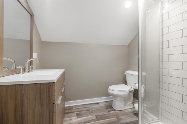 710 E Main St, Danville, KY 40422 - full bathroom featuring vanity, vaulted ceiling, toilet, tiled shower, and wood finished floors