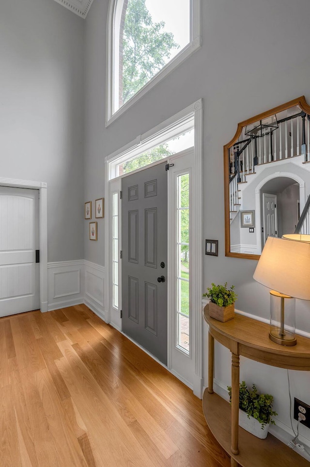 2245 Abbeywood Rd, Lexington, KY 40515 - entryway with a towering ceiling, plenty of natural light, light wood-style floors, stairs, and wainscoting