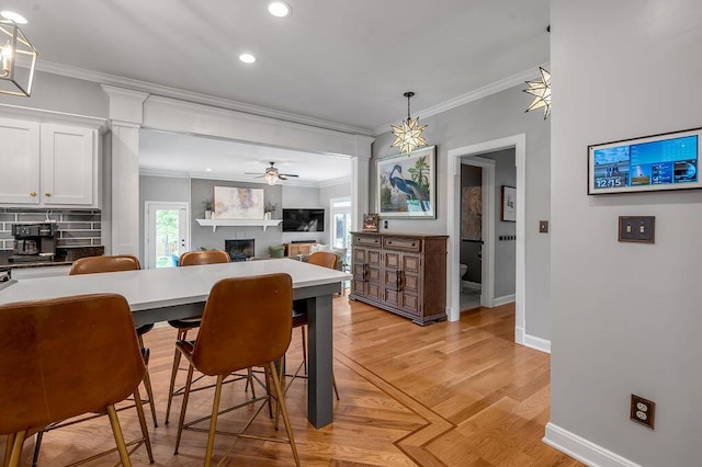 2245 Abbeywood Rd, Lexington, KY 40515 - dining room with ornamental molding, a brick fireplace, recessed lighting, baseboards, and light wood-type flooring