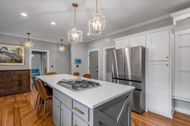 2245 Abbeywood Rd, Lexington, KY 40515 - kitchen with appliances with stainless steel finishes, a chandelier, a center island, white cabinetry, and light countertops