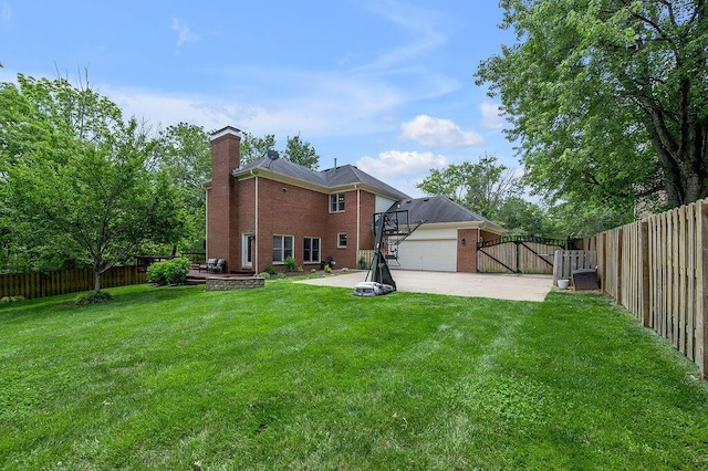 2245 Abbeywood Rd, Lexington, KY 40515 - rear view of property featuring brick siding, a wooden deck, a chimney, a gate, and concrete driveway
