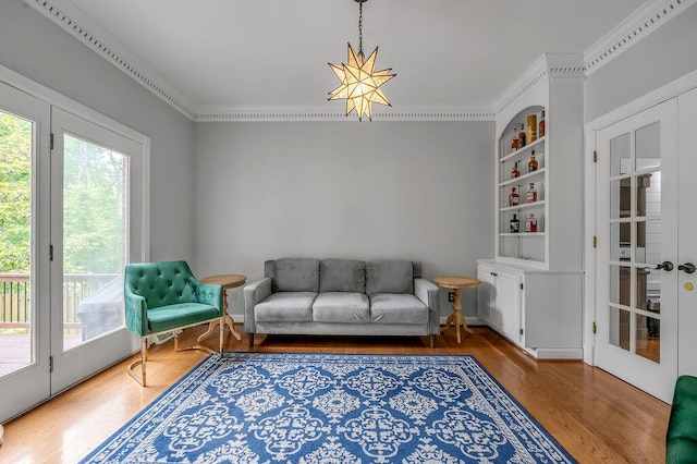 2245 Abbeywood Rd, Lexington, KY 40515 - sitting room featuring wood finished floors, built in shelves, crown molding, and french doors