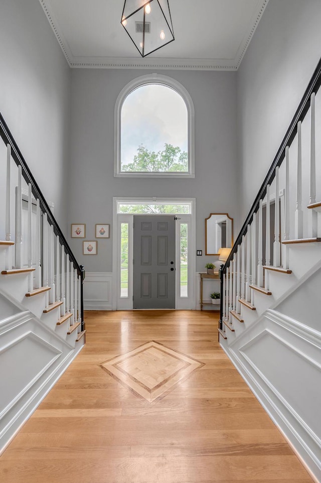 2245 Abbeywood Rd, Lexington, KY 40515 - foyer with a towering ceiling, stairway, wood finished floors, and ornamental molding