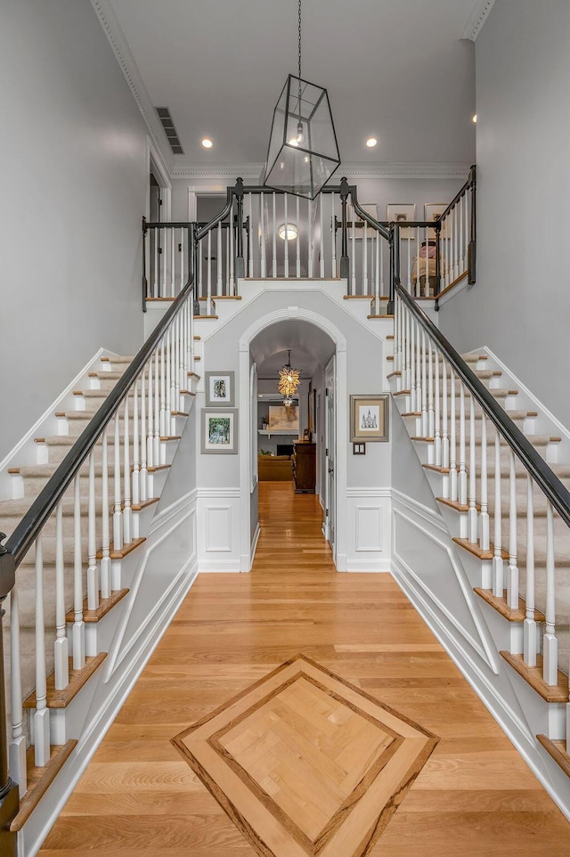 2245 Abbeywood Rd, Lexington, KY 40515 - stairway featuring arched walkways, crown molding, recessed lighting, a chandelier, and a towering ceiling