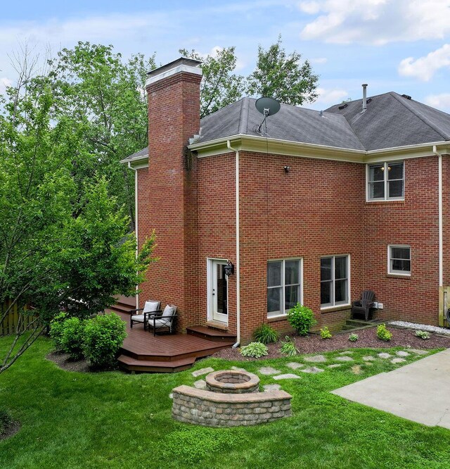2245 Abbeywood Rd, Lexington, KY 40515 - rear view of house featuring a fire pit, a deck, a yard, and a chimney