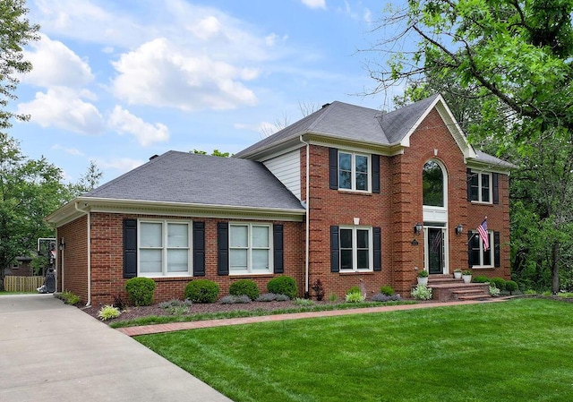 2245 Abbeywood Rd, Lexington, KY 40515 - view of front facade featuring brick siding, a front yard, and roof with shingles