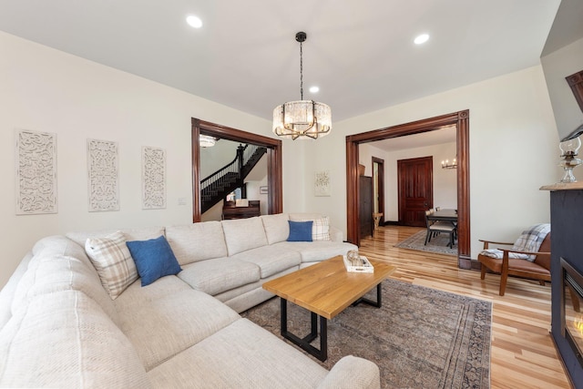 105 E 4th St, Augusta, KY 41002 - living room with a chandelier, stairway, light wood-style flooring, and recessed lighting