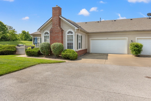 196 Academy Dr, Wilmore, KY 40390 - view of property exterior featuring a chimney, driveway, an attached garage, a shingled roof, and a yard