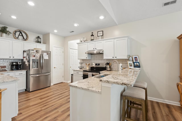 196 Academy Dr, Wilmore, KY 40390 - kitchen featuring stainless steel appliances, under cabinet range hood, light wood-style floors, white cabinets, and backsplash