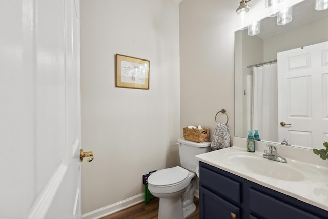 196 Academy Dr, Wilmore, KY 40390 - full bath with vanity, toilet, wood finished floors, baseboards, and a shower with curtain