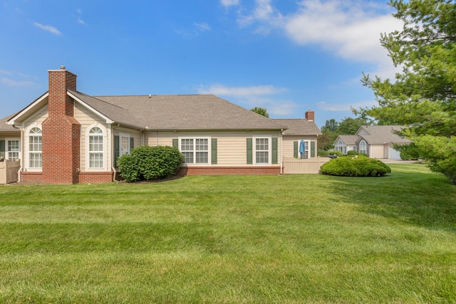 196 Academy Dr, Wilmore, KY 40390 - rear view of house featuring a chimney, brick siding, and a yard