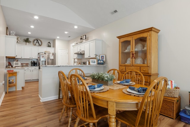 196 Academy Dr, Wilmore, KY 40390 - dining room with light wood finished floors, vaulted ceiling, and recessed lighting
