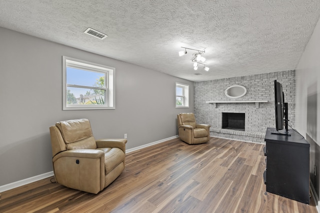 263 S Eagle Creek Dr, Lexington, KY 40515 - sitting room with a fireplace, baseboards, wood finished floors, and a textured ceiling