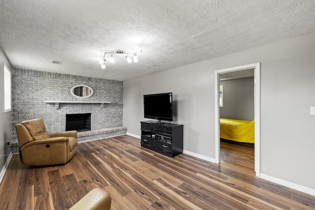 263 S Eagle Creek Dr, Lexington, KY 40515 - unfurnished living room with wood finished floors, a fireplace, baseboards, and a textured ceiling