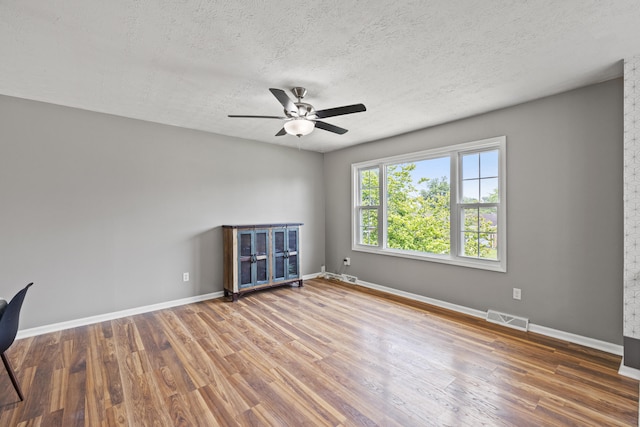263 S Eagle Creek Dr, Lexington, KY 40515 - unfurnished room featuring a ceiling fan, wood finished floors, baseboards, and a textured ceiling