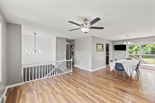 263 S Eagle Creek Dr, Lexington, KY 40515 - dining area with a chandelier, baseboards, wood finished floors, a ceiling fan, and a textured ceiling