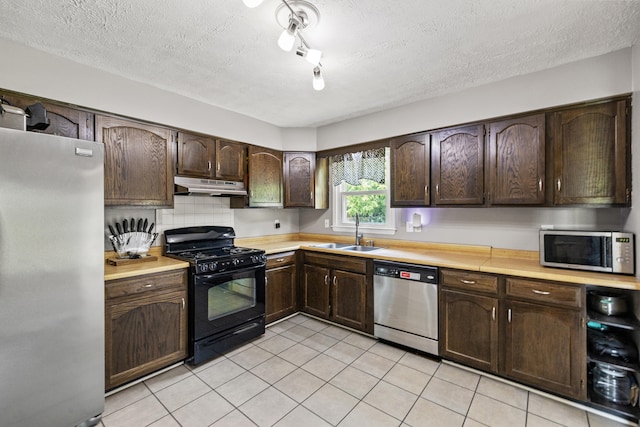 263 S Eagle Creek Dr, Lexington, KY 40515 - kitchen with appliances with stainless steel finishes, under cabinet range hood, a sink, light countertops, and light tile patterned floors