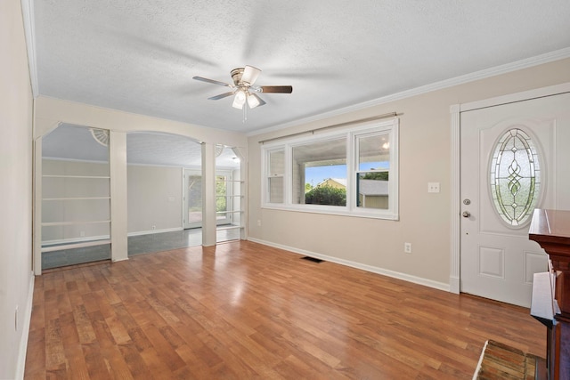 1780 Ballard Rd, Lawrenceburg, KY 40342 - foyer entrance with a ceiling fan, wood finished floors, a textured ceiling, ornamental molding, and arched walkways