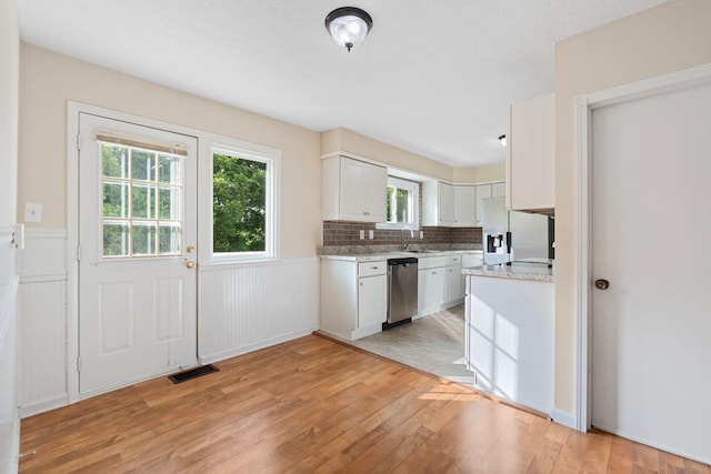 1780 Ballard Rd, Lawrenceburg, KY 40342 - kitchen featuring fridge with ice dispenser, dishwasher, light wood-style floors, white cabinets, and plenty of natural light