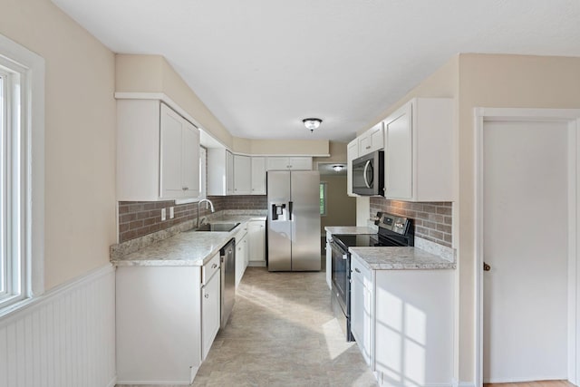 1780 Ballard Rd, Lawrenceburg, KY 40342 - kitchen with stainless steel appliances, light countertops, backsplash, and white cabinets