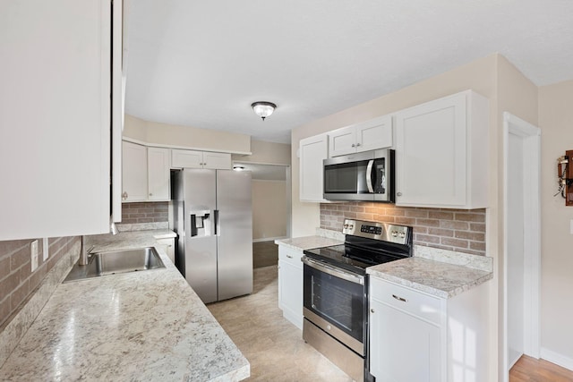 1780 Ballard Rd, Lawrenceburg, KY 40342 - kitchen featuring stainless steel appliances, backsplash, white cabinets, light countertops, and light wood-style flooring