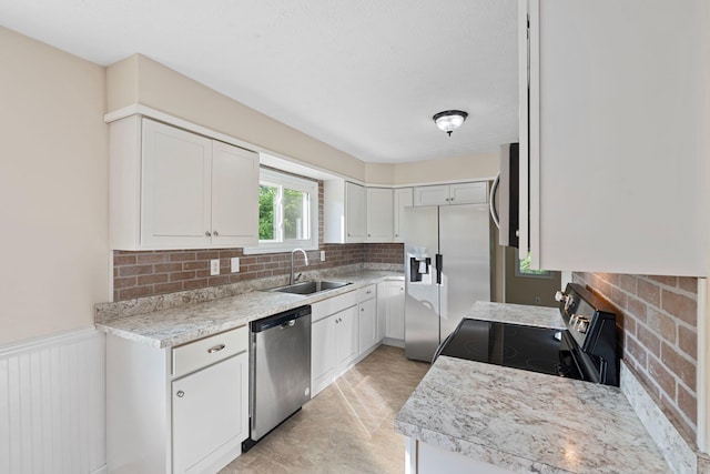 1780 Ballard Rd, Lawrenceburg, KY 40342 - kitchen featuring appliances with stainless steel finishes, tasteful backsplash, white cabinetry, light countertops, and wainscoting
