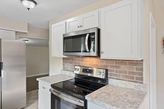 1780 Ballard Rd, Lawrenceburg, KY 40342 - kitchen with stainless steel appliances, decorative backsplash, light countertops, white cabinets, and a textured ceiling