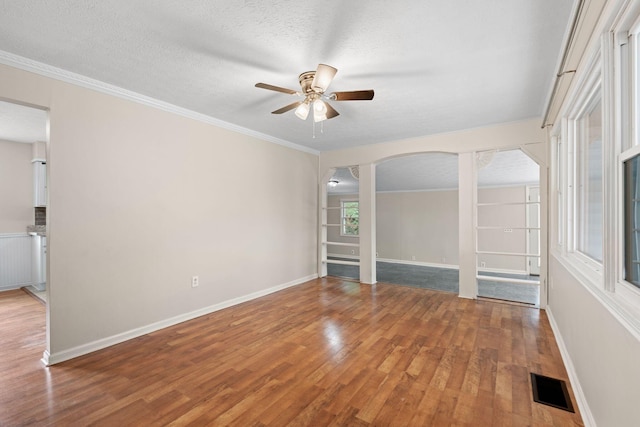 1780 Ballard Rd, Lawrenceburg, KY 40342 - empty room with a ceiling fan, arched walkways, light wood-style flooring, crown molding, and a textured ceiling