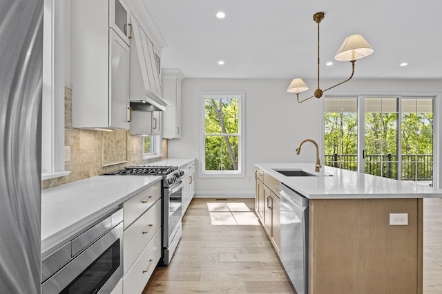 3521 Harper Woods Ln, Lexington, KY 40515 - kitchen with stainless steel appliances, a sink, recessed lighting, light countertops, and a kitchen island with sink