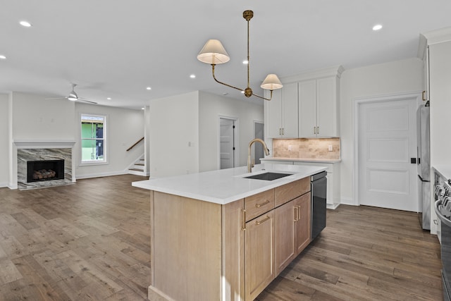 3521 Harper Woods Ln, Lexington, KY 40515 - kitchen featuring a sink, tasteful backsplash, dark wood finished floors, a kitchen island with sink, and light countertops