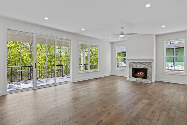 3521 Harper Woods Ln, Lexington, KY 40515 - unfurnished living room with a ceiling fan, baseboards, a premium fireplace, wood finished floors, and recessed lighting