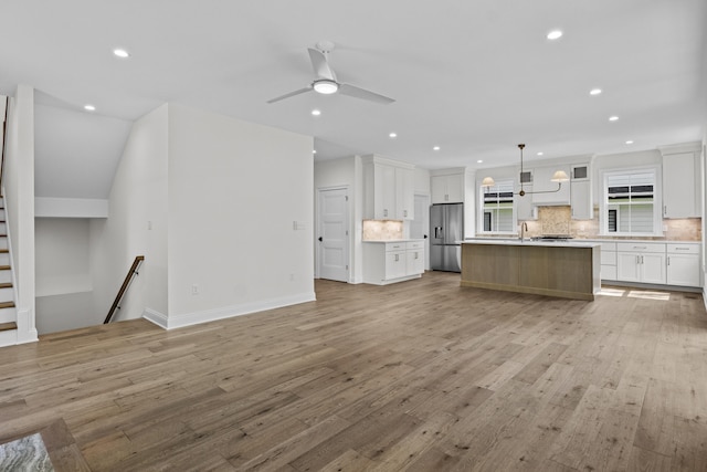 3521 Harper Woods Ln, Lexington, KY 40515 - unfurnished living room with light wood finished floors, recessed lighting, ceiling fan, a sink, and baseboards