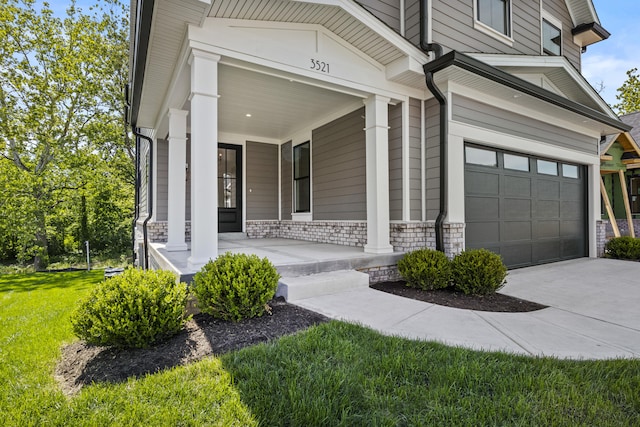 3521 Harper Woods Ln, Lexington, KY 40515 - view of exterior entry featuring covered porch, an attached garage, a lawn, and driveway