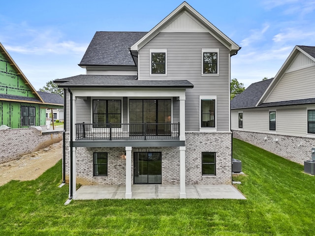3521 Harper Woods Ln, Lexington, KY 40515 - rear view of property featuring brick siding, central AC, a patio area, a balcony, and a lawn