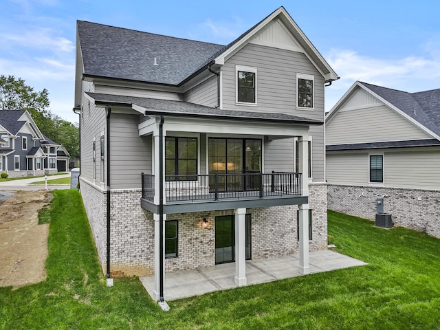 3521 Harper Woods Ln, Lexington, KY 40515 - rear view of property featuring brick siding, a patio, a balcony, a yard, and a shingled roof