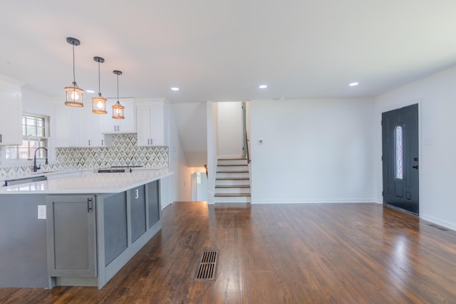 1613 Hastings Ct, Lexington, KY 40505 - kitchen featuring light countertops, white cabinetry, decorative backsplash, dark wood finished floors, and recessed lighting