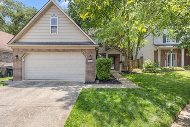 1748 Chandler Ln, Lexington, KY 40504 - view of front of home with brick siding, driveway, a front yard, and a garage