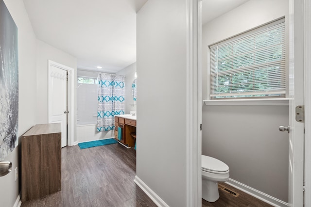 1748 Chandler Ln, Lexington, KY 40504 - bathroom with toilet, wood finished floors, vanity, tiled shower / bath, and baseboards