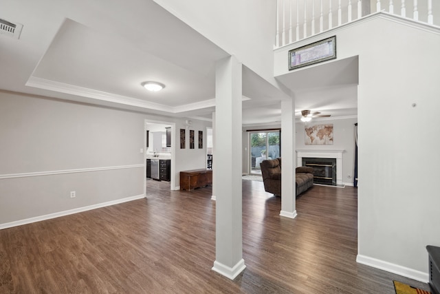 1748 Chandler Ln, Lexington, KY 40504 - unfurnished living room with dark wood-type flooring, ceiling fan, a glass covered fireplace, baseboards, and crown molding