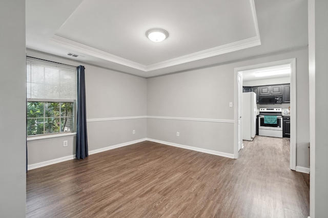 1748 Chandler Ln, Lexington, KY 40504 - unfurnished room featuring a tray ceiling, crown molding, wood finished floors, and baseboards