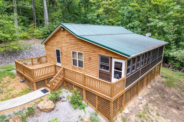 1150 Haynes Knob Rd, Somerset, KY 42501 - rear view of house with a wooden deck, metal roof, a sunroom, and a forest view