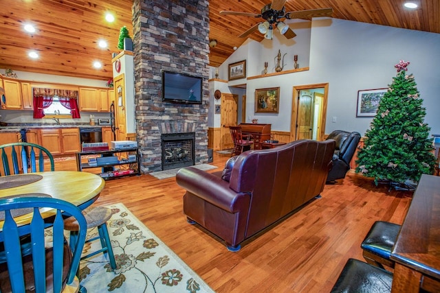 1150 Haynes Knob Rd, Somerset, KY 42501 - living room with wood ceiling, a stone fireplace, a ceiling fan, light wood-style floors, and a wainscoted wall