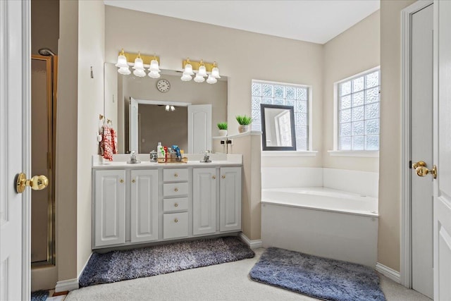 2713 Ella Rae Ct, Lexington, KY 40511 - bathroom featuring double vanity, a garden tub, and baseboards